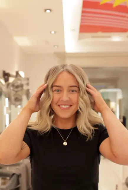 Happy smiling hair client after grey blending technique applied to coloured hair